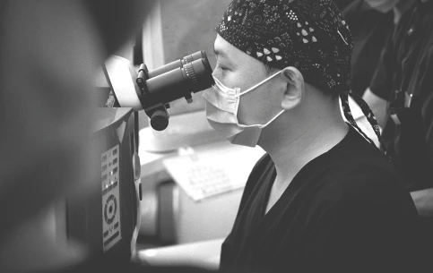 Ophthalmologist examining an eye with a clinical microscope